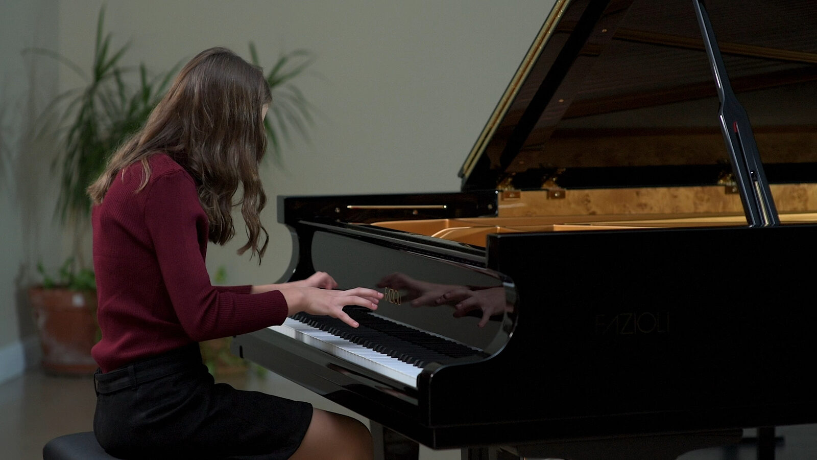 Lauren Connell at a grand piano, performing Beethoven’s 6 Écossaises in E-flat major, WoO 83