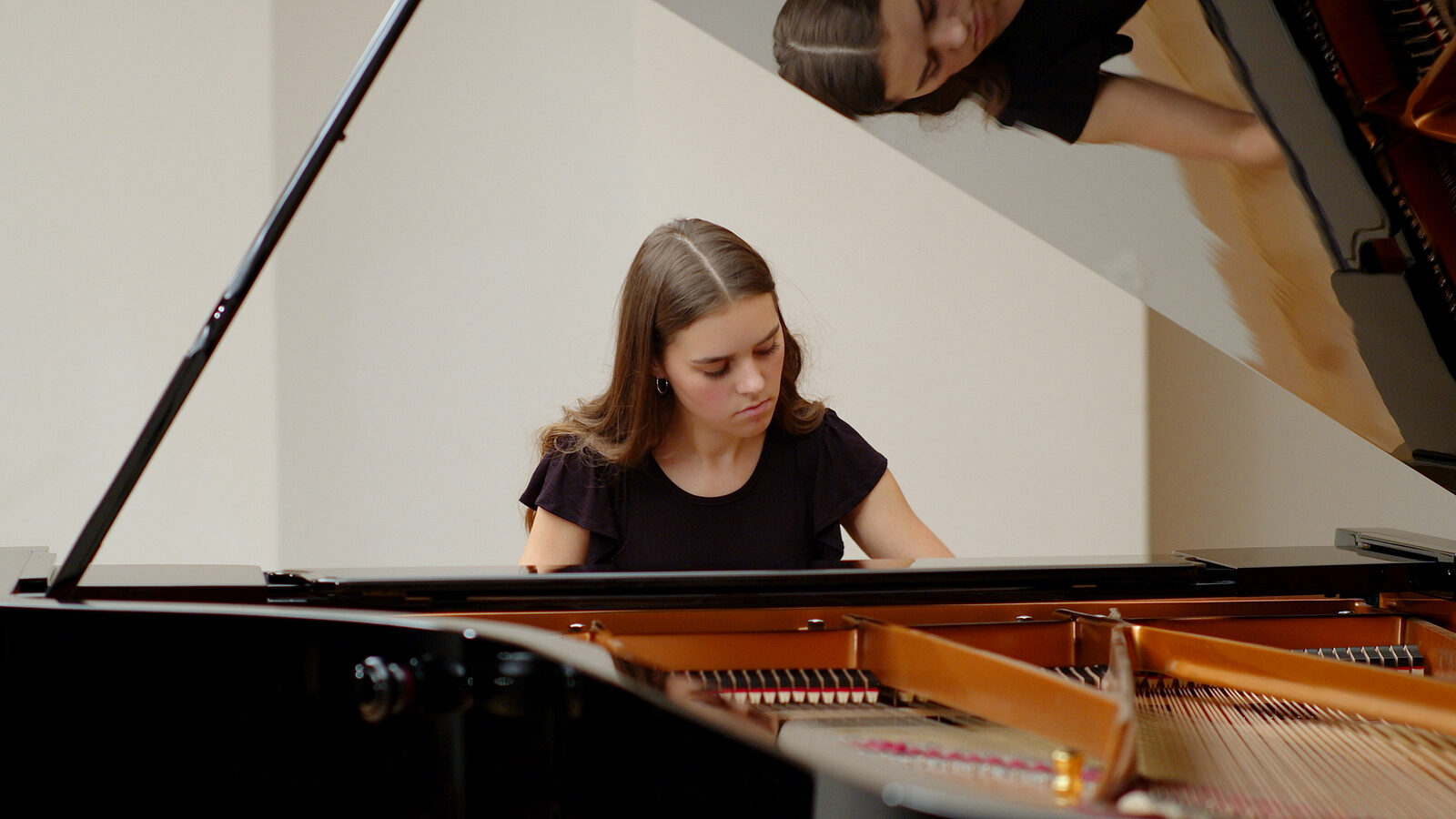 Lauren Connell at a grand piano, performing Chopin’s Nocturne Op. 9, No. 2