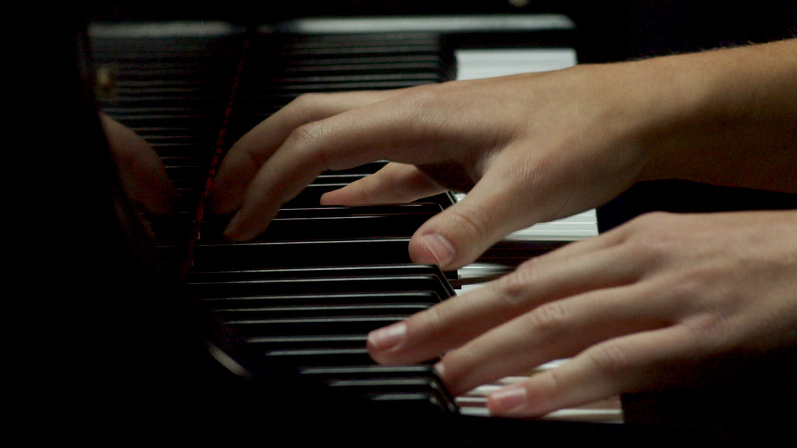 Close-up of Lauren Connell’s hands on the keys, performing Schubert’s Impromptu No. 3 in G-flat major